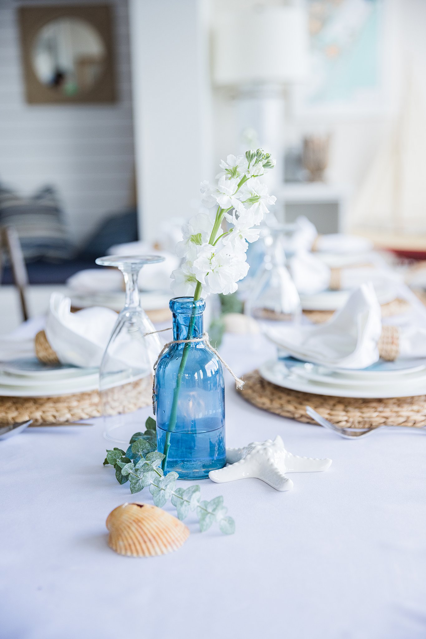 Details of a sea shell and beach themed wedding reception table set up