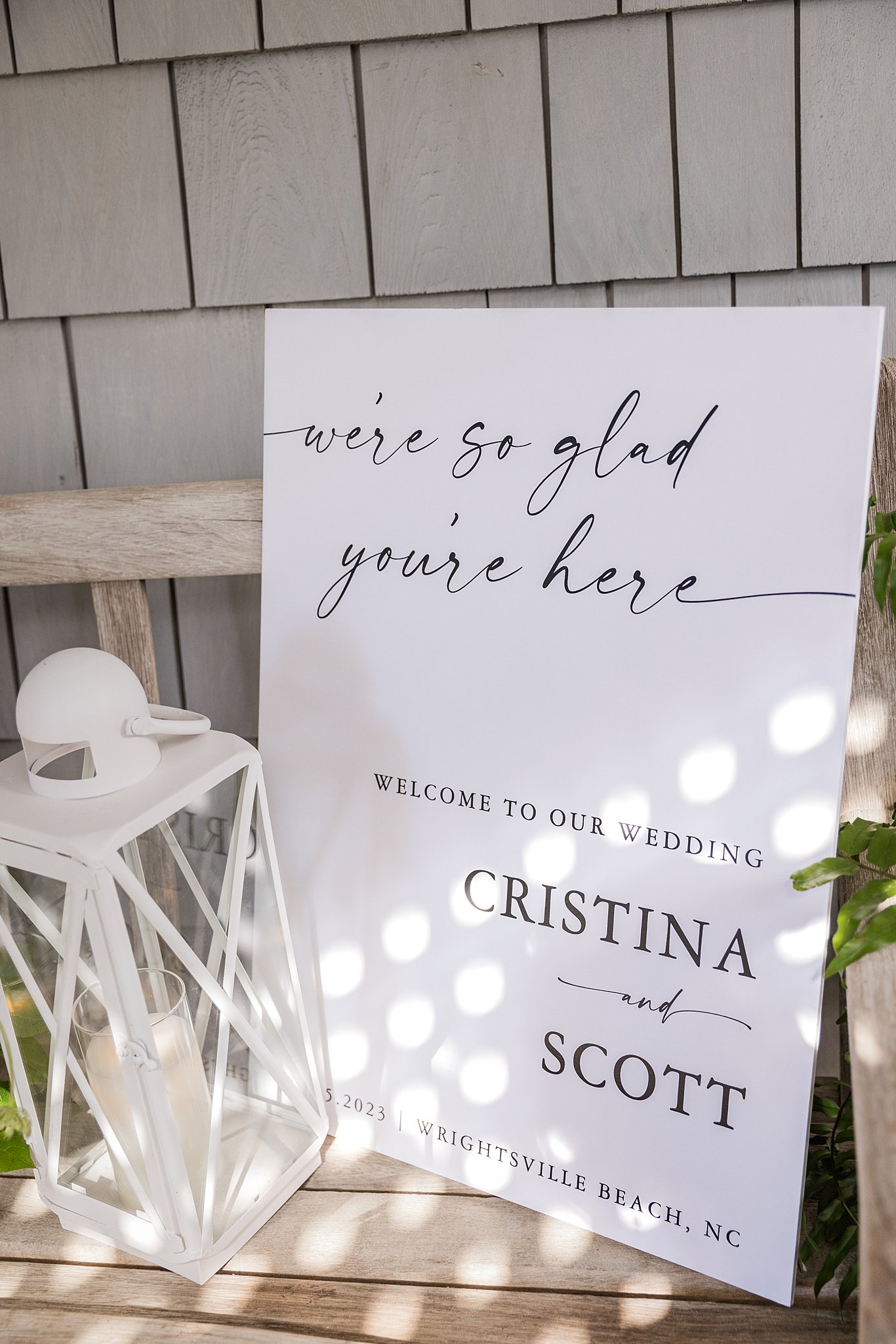 Details of a welcome sign for a wrightsville beach wedding and elopement sitting on a wooden bench