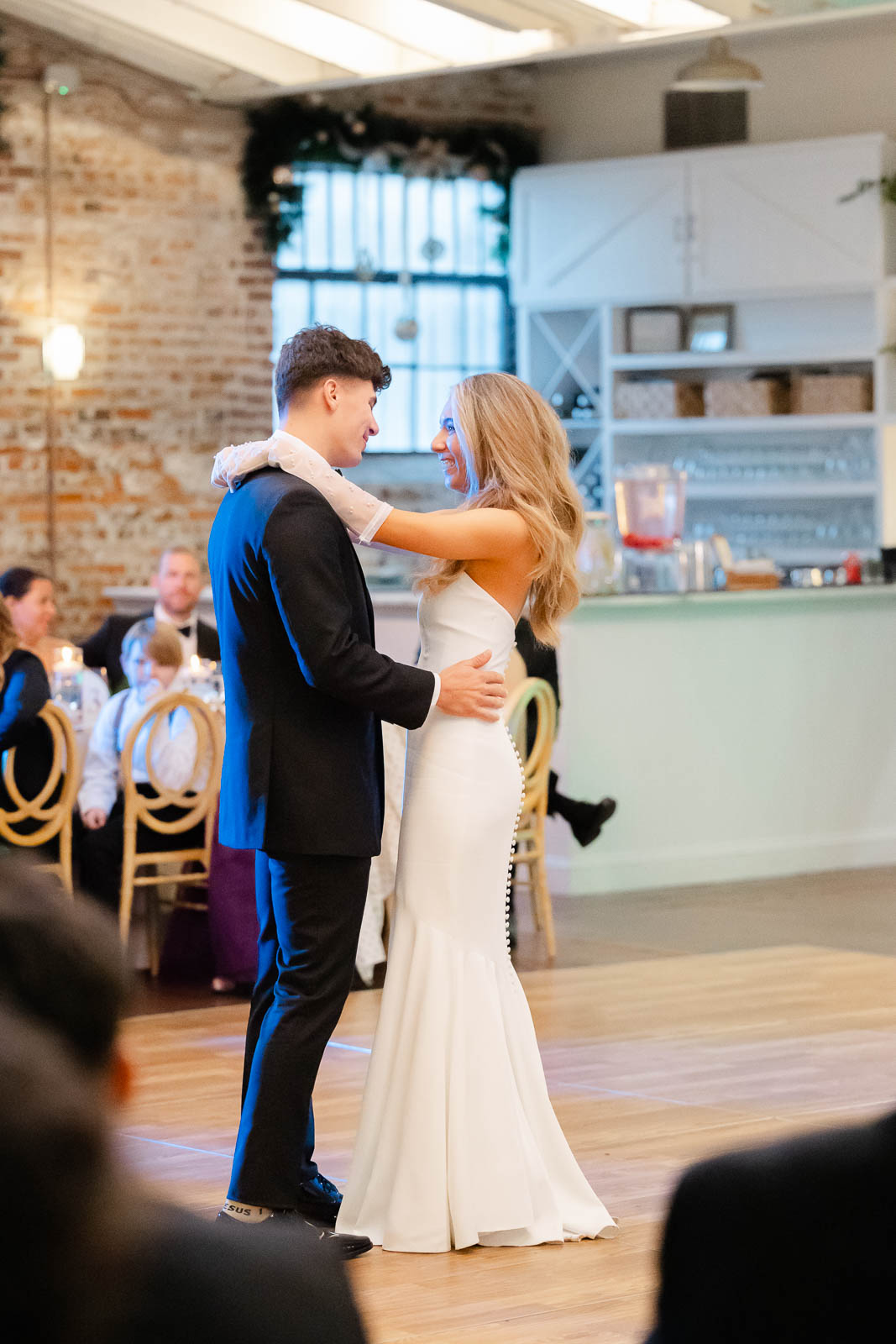 Newlyweds dance alone on the dance floor during their Bakery 105 wedding reception